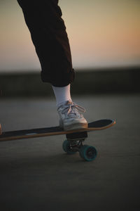 Low section of man skateboarding on floor