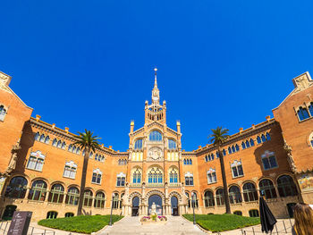 Low angle view of historical building against blue sky