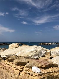 Rocks on beach against sky