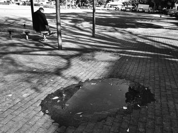 Man walking on sidewalk in city