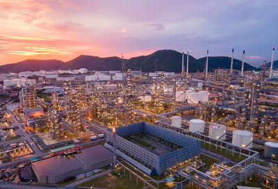 High angle view of illuminated city against sky during sunset