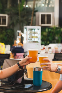 Midsection of woman using laptop at table