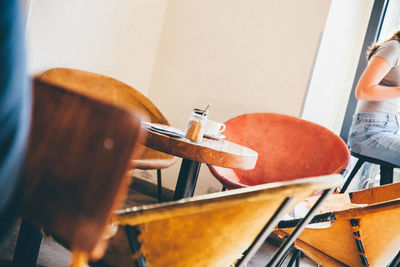 Midsection of woman sitting in cafe