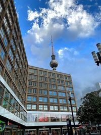 Low angle view of building against cloudy sky