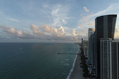 Panoramic view of sea and buildings against sky