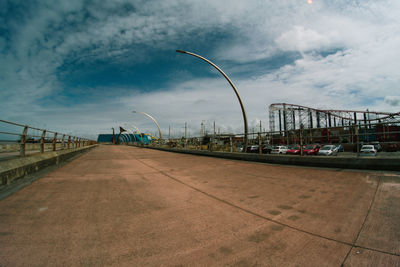 Bridge over street in city against sky