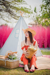 Portrait of young woman sitting in tent