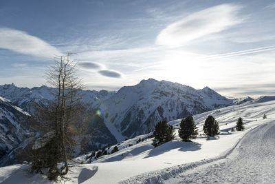 Scenic view of snow covered mountains against sky