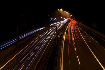 High angle view of light trails on highway at night