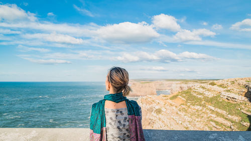 Rear view of woman standing on beach