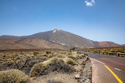 Road in desert against clear sky