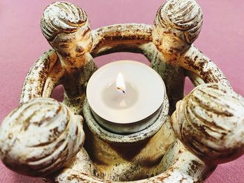 High angle view of illuminated candles on table