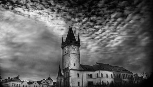 Low angle view of clock tower against sky in city