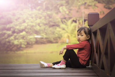Portrait of a little girl sitting outdoors