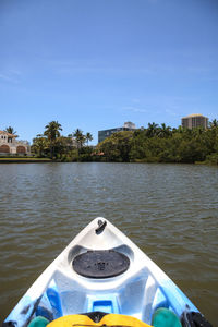 View of boat in river against blue sky