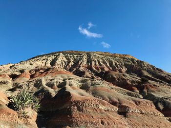 Low angle view of rock formation against sky