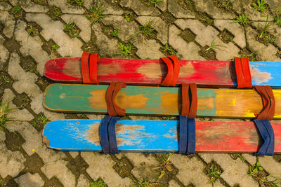 High angle view of empty bench against wall