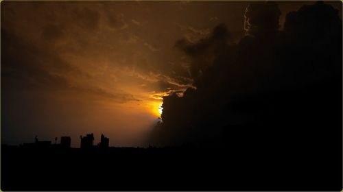 Silhouette of city during sunset