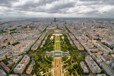 High angle view of city buildings against cloudy sky