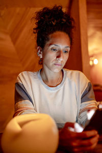 Woman using a mobile phone indoors.