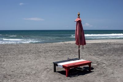 Lifeguard hut on beach against sky