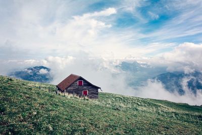 House on mountain against sky