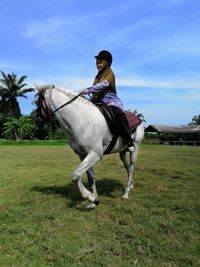 Man riding horse on field