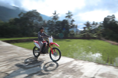 Man riding bicycle on road