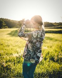 Side view of woman standing on field