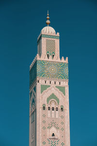 Low angle view of clock tower against blue sky