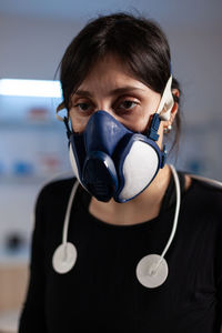 Portrait of man wearing mask against white background