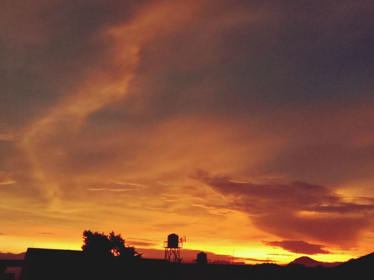 sky, cloud, sunset, afterglow, silhouette, dawn, horizon, orange color, evening, nature, beauty in nature, red sky at morning, architecture, dramatic sky, scenics - nature, built structure, building exterior, outdoors, sunlight, environment, sun, no people, tranquility, landscape, tranquil scene, building