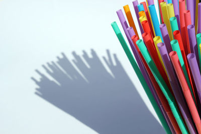 High angle view of colored pencils on white background
