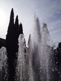 Water splashing in sea against sky