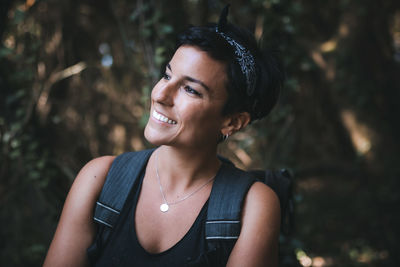 Portrait of a smiling young woman standing outdoors