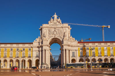 Low angle view of historical building against clear blue sky