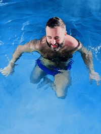 High angle view of man swimming in pool