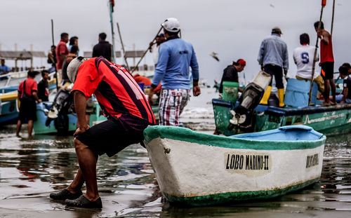 People on wet boat in sea