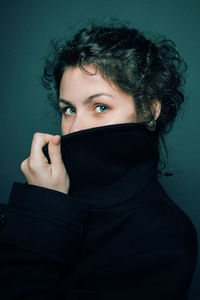 Portrait of woman covering face