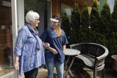 Nurse walking with elderly woman