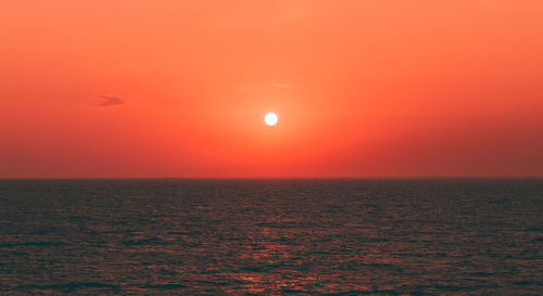 Scenic view of sea against romantic sky at sunset