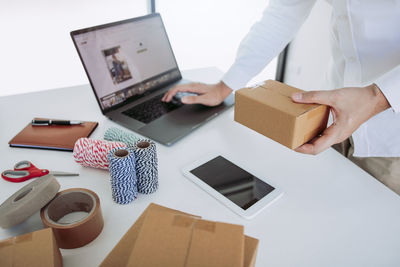 High angle view of woman using laptop on table