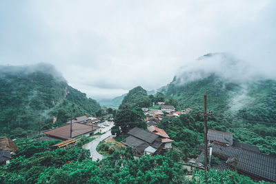 High angle view of houses and trees against sky