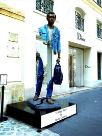 Full length of man standing by text on wall