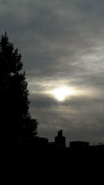 Low angle view of silhouette tree against cloudy sky