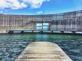 Bridge over swimming pool against sky