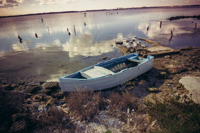 Abandoned boats moored on shore