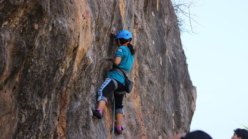 Young woman standing on rock