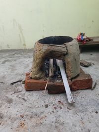 High angle view of abandoned chair on table against wall