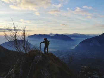 Man standing on mountain against sky